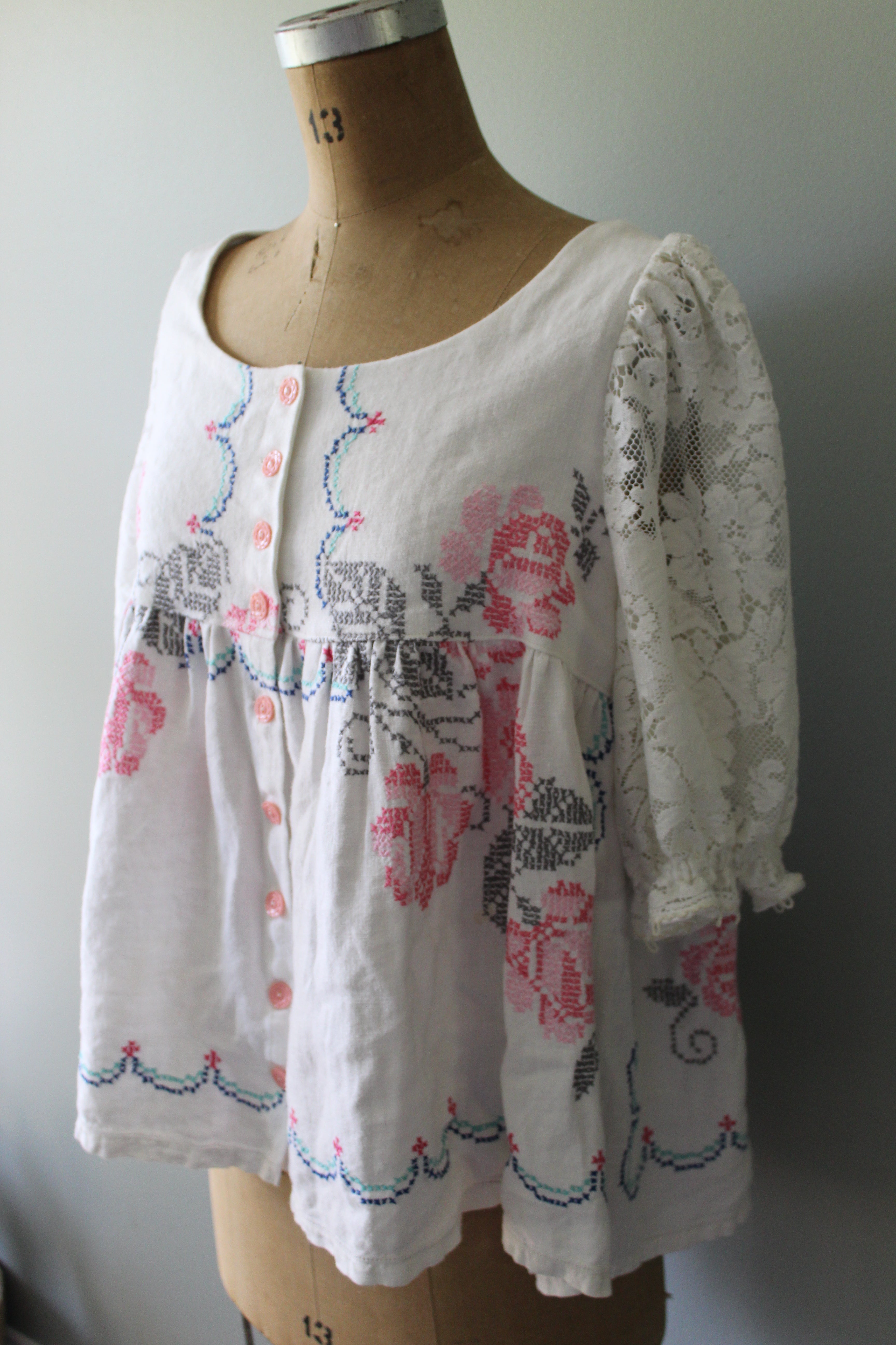 Floral-patterned blouse on a mannequin against a plain background