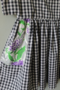 Black and white checkered fabric with a floral patterned pocket.