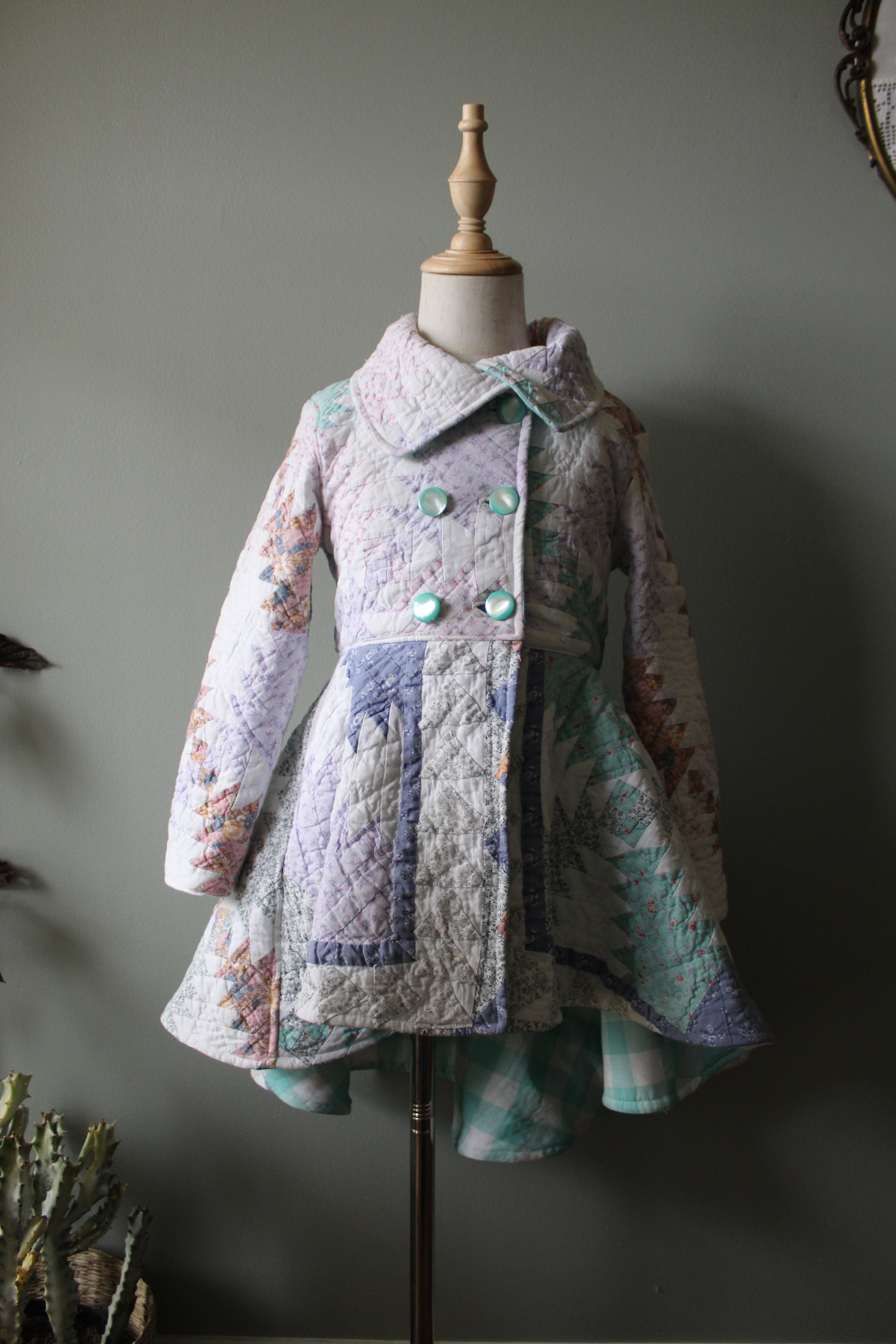 Quilted garment on a mannequin against a neutral background