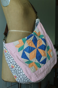 Colorful quilt bag draped over a mannequin.
