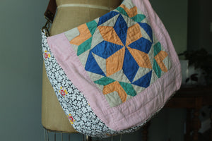 Quilted bag with geometric pattern on a mannequin against a neutral background