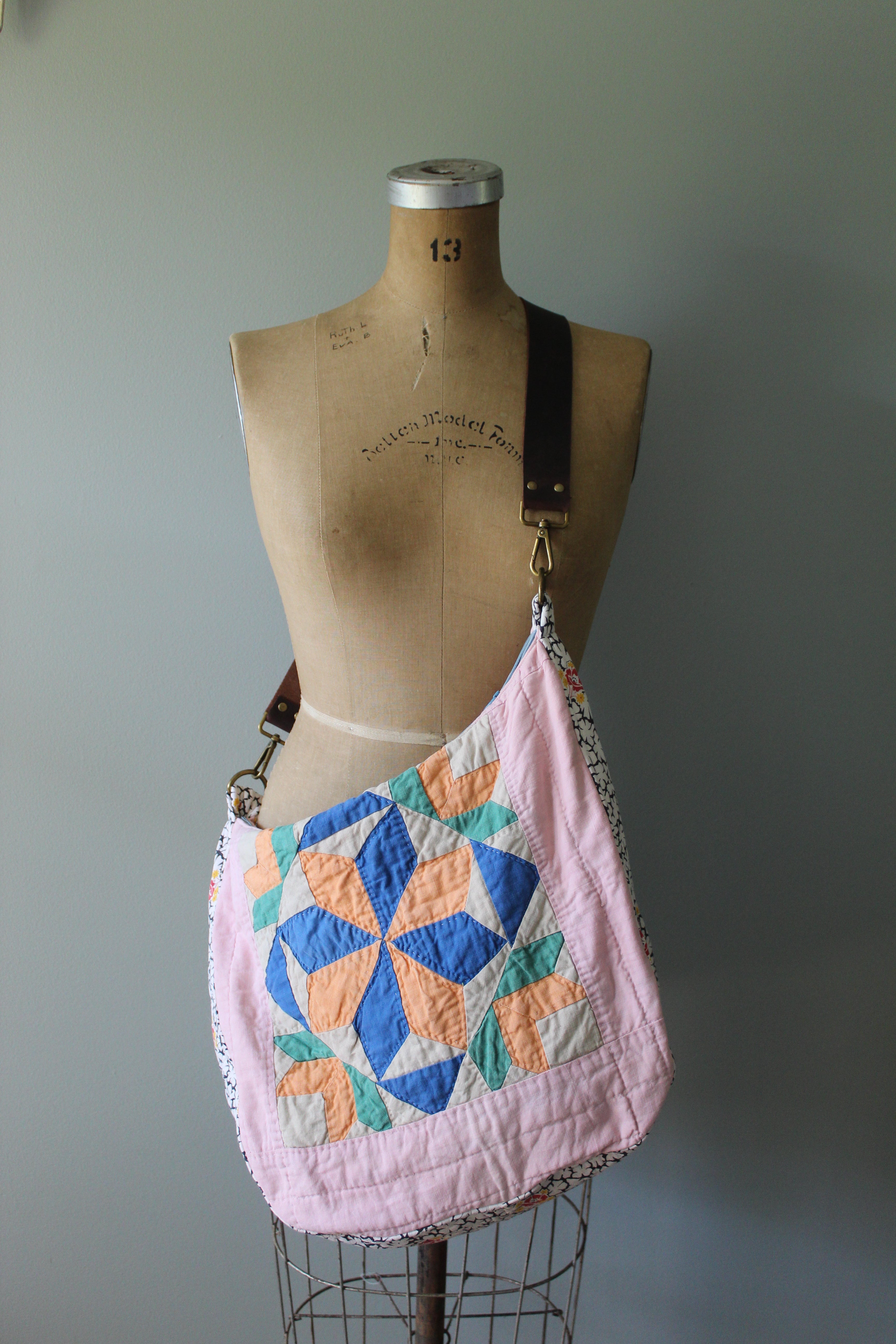 Quilted bag with geometric pattern on a mannequin against a plain background