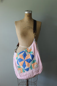 Quilted bag with geometric pattern on a mannequin against a plain background